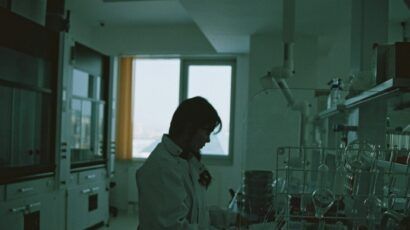 scientist in lab coat in dark room